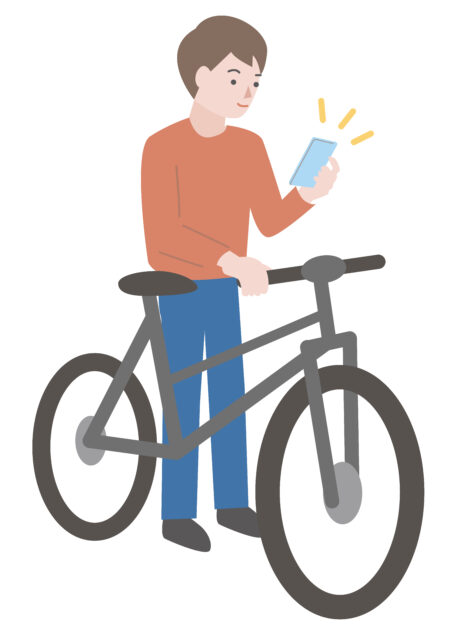 自転車を停めてスマホ操作する男性1